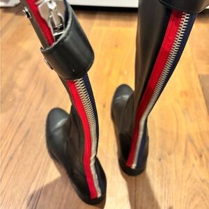 Steve Madden riding boot with red and blue ribbon detail on back zipper